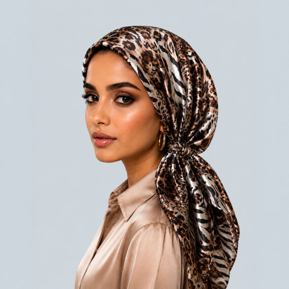 Model wearing the Bronzed Safari Mosaic animal print silk turban in warm bronze, tan, and black tones