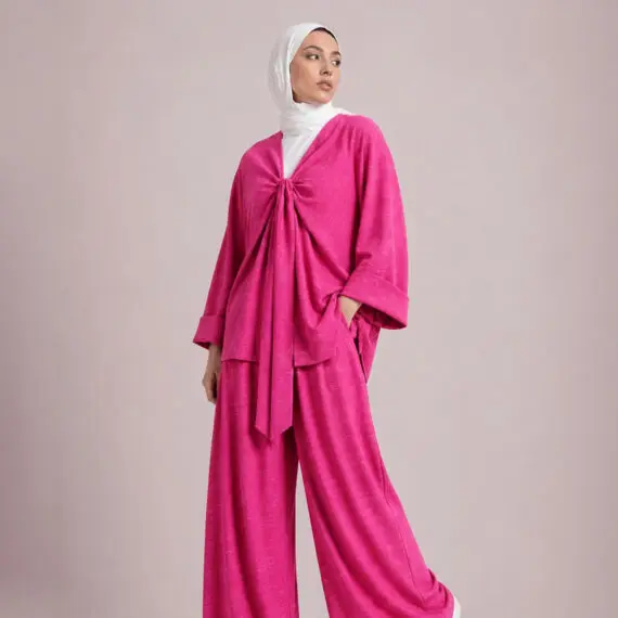 Vibrant hot pink linen cotton set featuring a knot-front top and wide-leg pants.