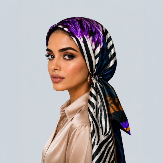 Model styled in the Violet Aurora satin headscarf, a bold purple and gold abstract zebra animal print turban